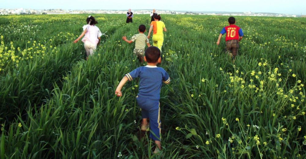 Children running through the fields